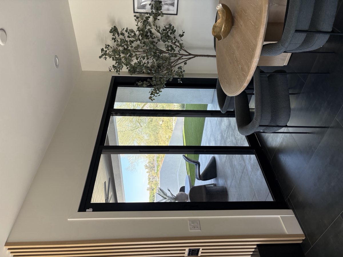 Kitchen view of completed wall cut-out with multipanel doors and backyard access