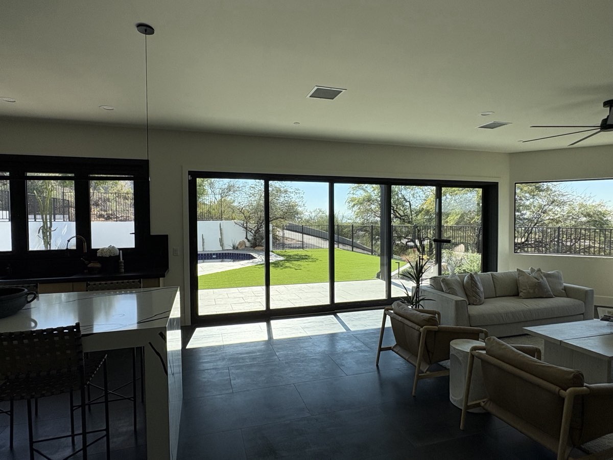 Phoenix home interior with multipanel sliding glass doors and backyard views